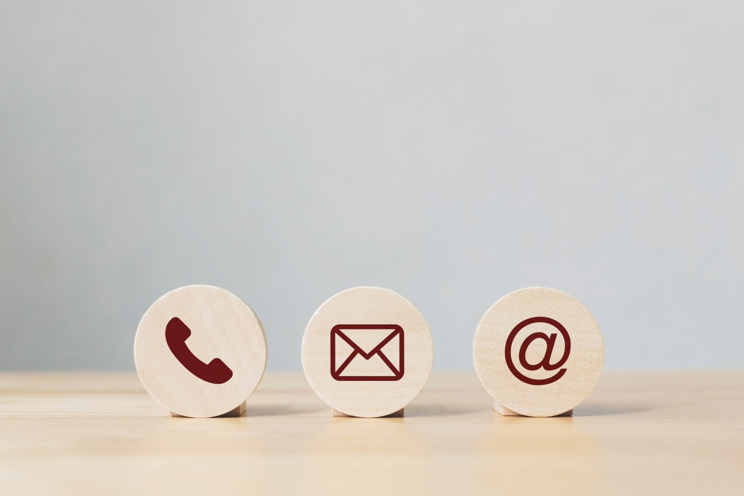 Wooden coins with symbol telephone, email, address. Website page contact us or e-mail marketing